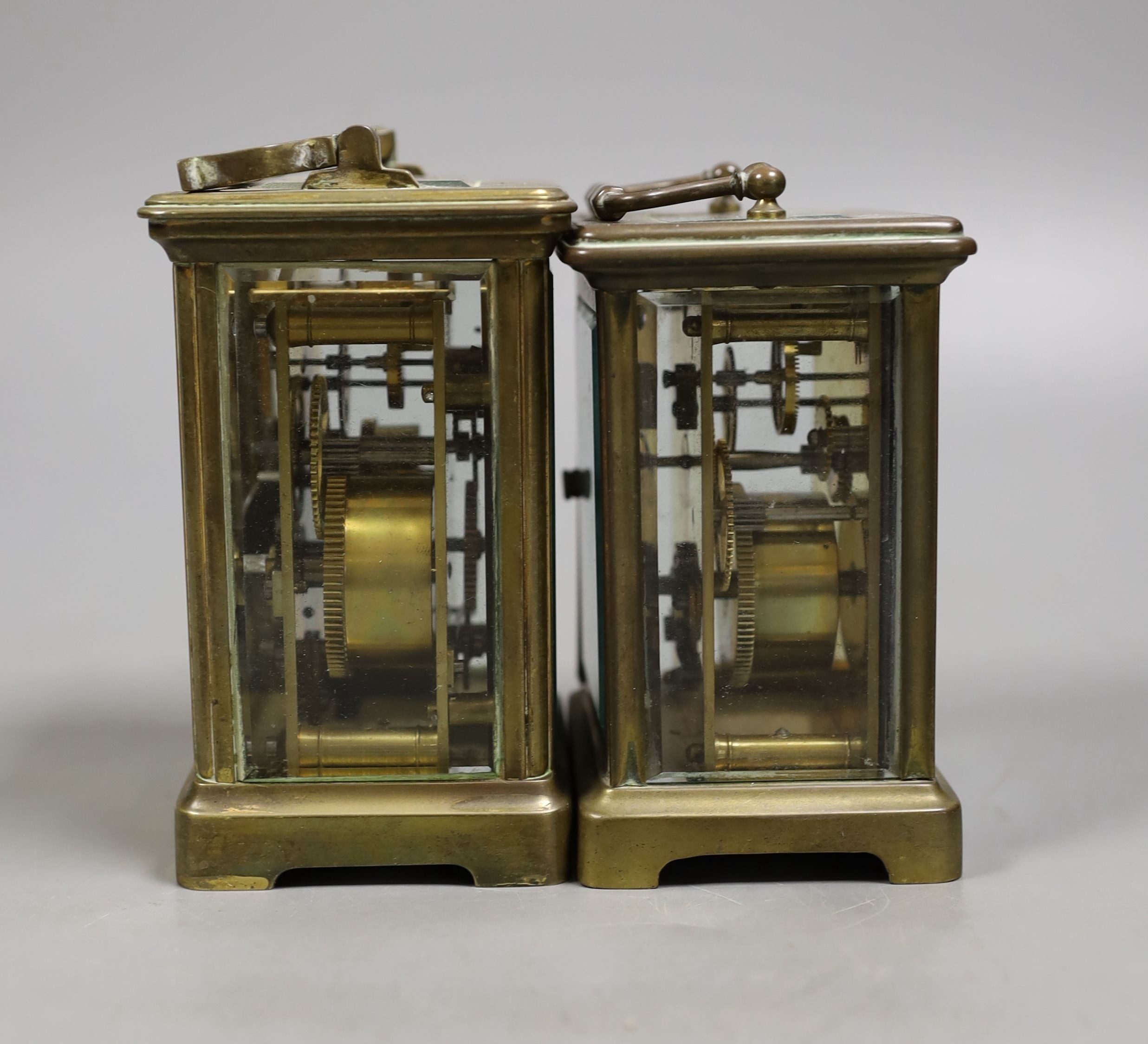 A French brass carriage timepiece with alarm and a French brass carriage timepiece, Tallest 11.5 cms high.